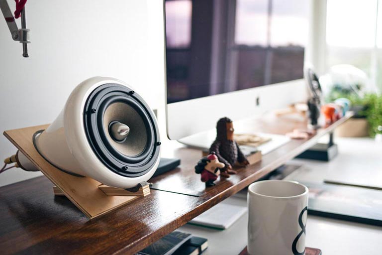 Speaker and figurines on a desk