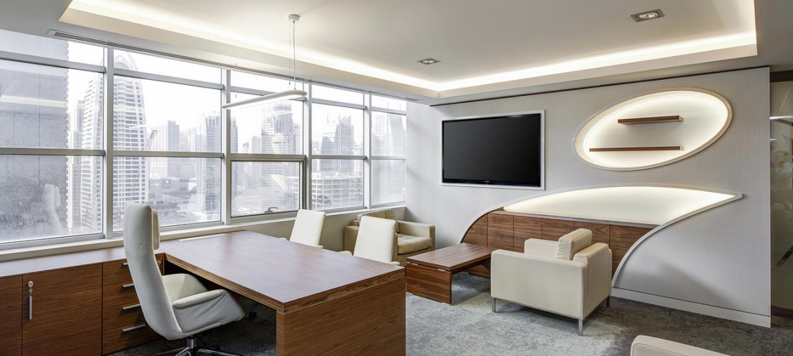 Bright, modern office lounge with a desk and sofas