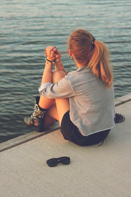 Designer relaxing by the water with a tablet