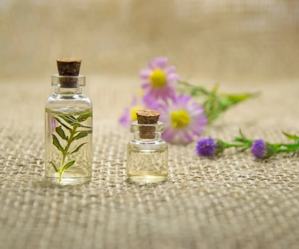 Botanical oils in glass bottles on linen